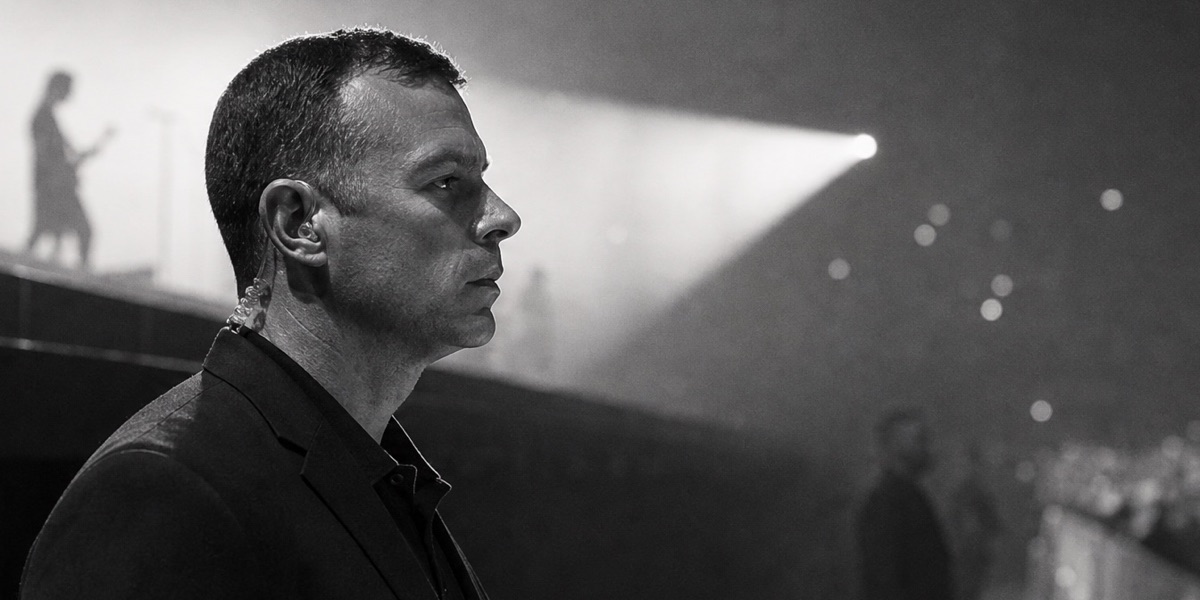 Event security officer at the stage barrier watching the crowd during a concert